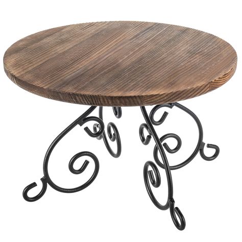 PRICES MAY VARY. Burnt wood and black metal scrollwork dessert riser adds modern rustic flair at a birthday party, wedding, baby shower, or commercial business **Some assembly required** 12-inch-round cake stand is crafted of a 0.8-inch-thick wooden board with an 8mm gauge metal wire base for functional and elegant tabletop décor Ideal for serving a single cake or pie up to 11 inches in diameter, or a platter of cupcakes, muffins, cookies, doughnuts, or hors d'ouveres **Pictured items not includ Iron Cake Stand, Unique Cake Stands, Cake Display Stand, Pretty Cake Stands, Dream Bakery, Torch Wood, Wood And Black Metal, Rustic Cake Stands, Metal Cake Stand