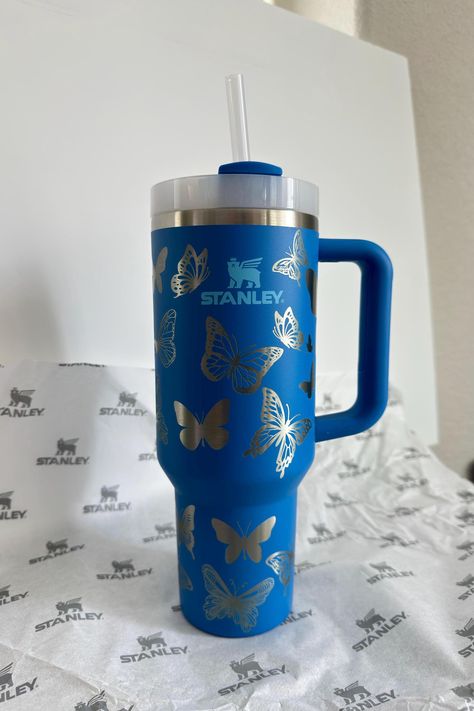 40 oz Stanley Quencher release. It's even more beautiful with the engravings and colors contrasting.  It's an authentic Stanley 40oz Stanley Quencher 40 oz in Azure blue  color  Laser engraved by me.  Perfect gift! Engraved butterflies fully wrap the the tumbler in a seamless wrap.  The color is Azure blue with a butterfly theme absolutely stunning and adorable! Comes with original label. Permanently laser engraved -- design does not rub off or peel! ★ Stanley Brand ★ Double-Wall Vacuum Insulati Blue Stanley Cup, Blue Stanley, Stanley Mug, Stanley Brand, Blue Tumbler, Bedazzled Shoes, Trendy Water Bottles, Stanley Cups, Leyte