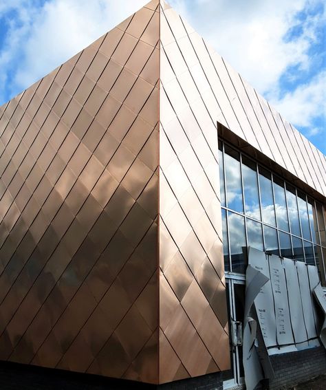 A progress shot of our very eye-catching Tecu Bronze shingle installation at the Seashell Trust in South Manchester. An example of fantastic workmanship by our craftsmen, which is part of a much larger roofing and cladding package we are carrying out for Willmott Dixon Construction. Eventually the bronze will develop a brown/red oxidation as it gradually changes to a dark brown anthracite appearance. #tecu #cladding #facade #construction #bronze #shinglecladding #rainscreen #constructionuk Bronze Cladding, Bronze Roof, Copper Cladding, Facade Inspiration, Zinc Cladding, Rainscreen Cladding, Metal Shingles, South Manchester, Exterior Wall Cladding