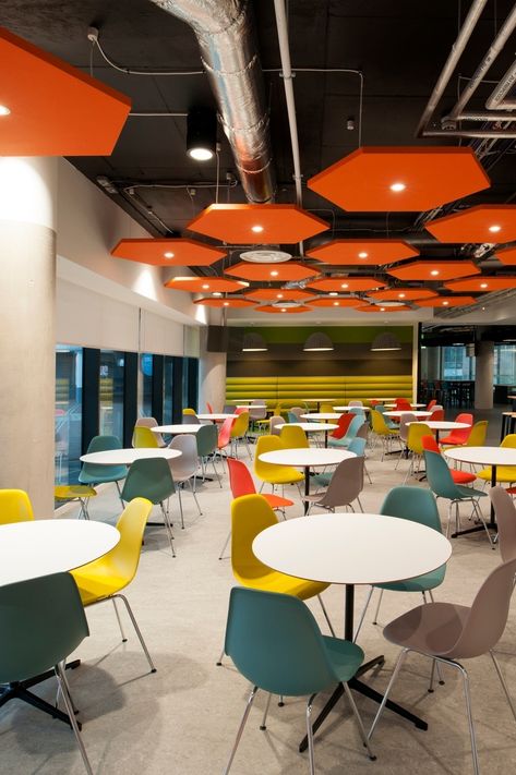 Workplace Cafe, Office Cafeteria Design, Fun Workplace, Cafeteria Furniture, Canteen Design, Yellow Chairs, Exposed Ceiling, Office Cafeteria, Orange Chairs