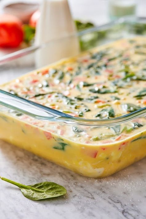 This easy Breakfast Casserole recipe is made with eggs, spinach, tomatoes and Feta cheese and only takes a few minutes to whip up. You can make it ahead of time, so it’s the perfect breakfast egg casserole for Christmas morning or any day! #breakfastcasserole Breakfast Casserole With Spinach, Casserole With Spinach, Tomatoes And Feta Cheese, Christmas Breakfast Casserole, Eggs Spinach, Easy Breakfast Casserole, Tomatoes And Feta, Easy Breakfast Casserole Recipes, Spinach Breakfast