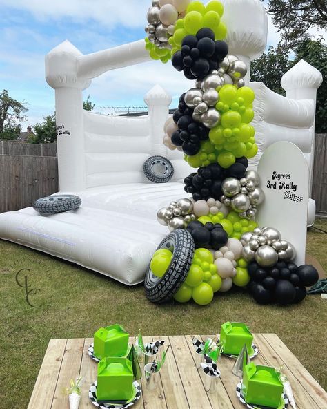 Lime Green Balloon Garland, Balloons On Bounce House, Monster Truck Balloon Arch, Monster Truck Balloons, Monster Truck Birthday Decor, Black Balloon Decor, White Bounce House With Balloons, Bounce House Balloon Garland, Monster Truck Birthday Party Decorations