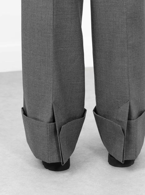 The Ox Pants from TOGA PULLA arrive in a grey. Made in Japan from a woollen blend, the mid-rise trousers fall to a relaxed fit with a voluminous taper. Front pleats and turn-ups at the cuff give the trousers their shape. A rear welt pocket and patch pocket sit below a shiny fabric detailing at the back of the trousers.  Fit:   Relaxed fit  Voluminous finish  Model is 5'9.5" and wears a S   Details:  Mid-rise trousers Belt loop  Front pleats  Rear fabric detail  Rear welt pocket and patch pocket  Turn ups  70% Polyester/30% Wool  COO: Japan  Colour: Grey . Department: Trousers , TOGA PULLA , Size: Small Clothes Details, Pleats Fashion, Fabric Detailing, Toga Pulla, Trousers Details, Trouser Pocket, Pants Details, Shiny Fabric, Back Details