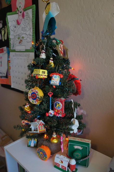 Fisher Price Ornament Tree. I have to do this next year! Vintage Fisher Price Toys, Mexican Christmas, Hallmark Christmas Ornaments, Ornament Display, Christmas Tabletop, Ornament Tree, Fisher Price Toys, Christmas Swags, Holiday Christmas Tree