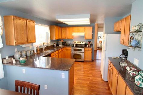 Honey Oak cabinetry and flooring with blue walls Light Blue Kitchen Walls, Blue Kitchen Walls, Light Blue Kitchen, Painting Kitchen Cabinets White, Little Castle, Light Blue Kitchens, Honey Oak Cabinets, Florida Kitchen, Family Area