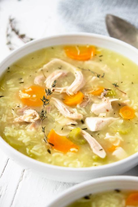 A close up of rotisserie chicken and rice soup in a white bowl Rotisserie Chicken And Rice Soup, Soup With Rotisserie Chicken, Rotisserie Chicken Uses, Rotisserie Chicken And Rice, Rotisserie Chicken Soup, Easy Chicken And Rice, Rice Soup Recipes, Chicken Rice Soup, Easy Dinner Recipes Crockpot