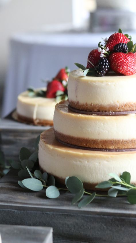 3 tier cake flanked by 2 side cakes. Just lovely! Cheesecake Tier Cake, 2 Tier Cheesecake Wedding Cake, Simple Wedding Cheesecake, 2 Tier Cheesecake, Cheesecakes For Weddings, 3 Tier Cheesecake, Cheesecake Grooms Cake, Cheesecake Wedding Cake Ideas Simple, Cheesecake For Wedding