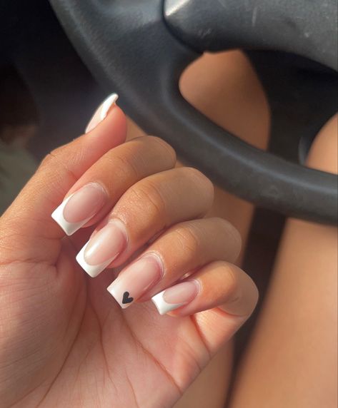 White french tip, classic french tip, classy nails, elegant nails, clean girl aesthetic nails, minimalistic nails, black heart accent nail, black heart nails, nails 2023 Black French Tips With Accent Nail, White Nails With Black Accent, White French Tip Nails With Black Design, White French Tip With Black Design, Tuxedo French Tip Nails, White Tips With Heart, Black And White French Tip Nails Square, French Tip Nails With Accent Nail, Black French Tip With Heart