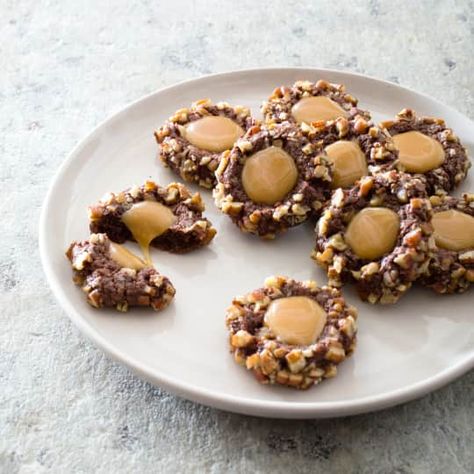 Chocolate Turtle Cookies | America's Test Kitchen Chocolate Turtle Cookies, Chocolate Turtle, Thumbprint Cookie, Pecan Turtles, Donut Toppings, Caramel Chocolate Bar, Turtle Cookies, Cookie Toppings, Chocolate Turtles