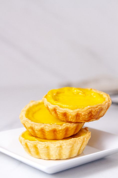 Egg Tarts are cute little tarts (usually about 3 inches in diameter) of delicate buttery flaky pastry crust filled with a silky-smooth egg custard. They're buttery, soft, lightly sweet, and such a delicious dessert treat. Egg Photography, Egg Tart Recipe, Asian Baking, Portuguese Tarts, Sweet Egg, Food Story, Egg Custard, Homemade Pastries, Pastry Shells