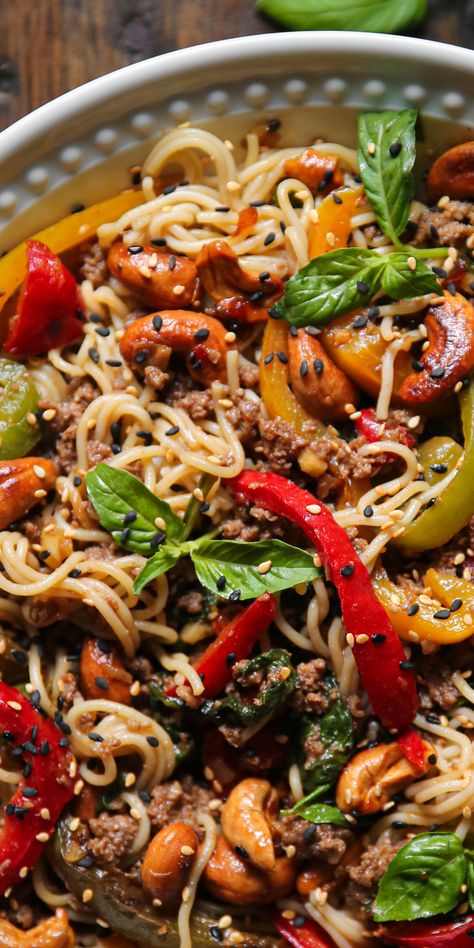 Beef Ramen Noodles with Bell Peppers, Spinach, Cashews, Sesame Seeds - in a white plate.