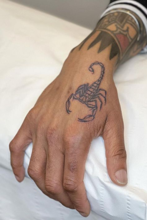 Request a booking with Sophie Rose Hunter in London directly via the link #tattoodo #scorpion #scorpiontattoo #blackandgreytattoo #handtattoo Scorpion Hand Tattoos For Guys, Minimal Scorpion Tattoo, Scorpion Tattoo Hand, Scorpion Arm Tattoo, Scorpion Tattoo Design Men, Guy Fawkes Tattoo, Inner Wrist Tattoos Men, Scorpion Hand Tattoo, Scorpion Tattoo For Men