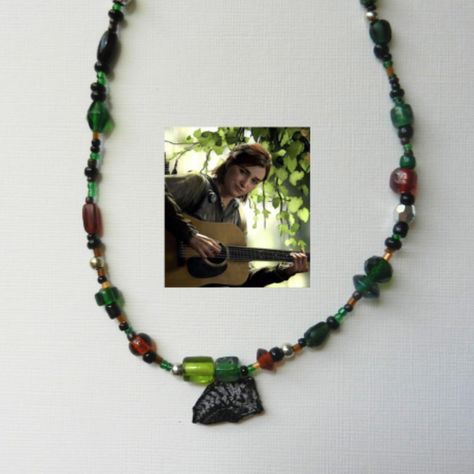 ellies tattoo from the last of us inspired beaded necklace Last Of Us, Green Brown, Silver Beads, The Game, Beaded Necklace, Tattoos, Beads, Silver, Green