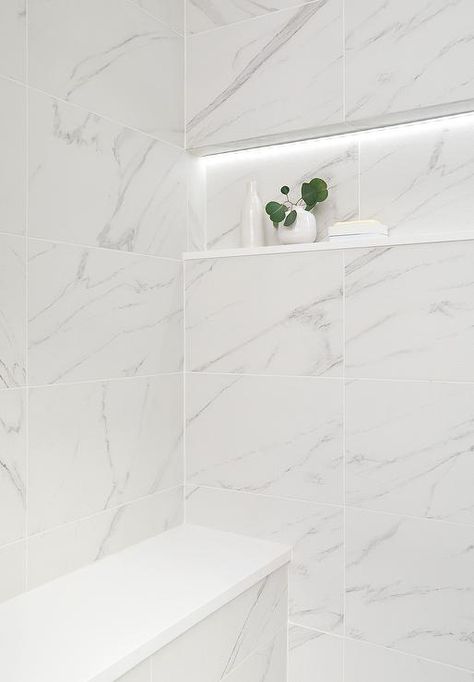 Shower features a marble niche with custom lighting over stacked marble shower wall tiles and a built in bench. Stacked Floor Tile, Marble Shower Niche, Marble Niche, Herringbone Shower Floor, Shower Wall Tiles, Prefab Walls, White Marble Shower, Marble Shower Walls, Tile Shower Niche