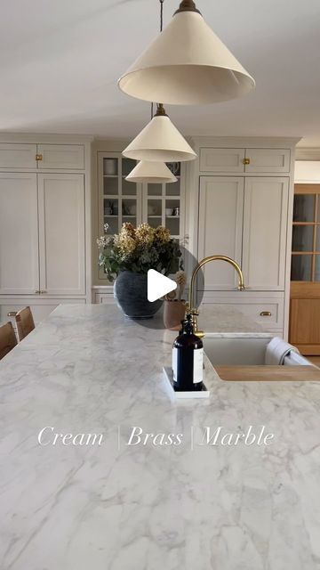 Emily Riter on Instagram: "We love getting the “new-old” feel in the kitchen with creamy paint, unlacquered brass, marble, sconces, white oak hardwood & island, and a timeless touch of black with a black range. What are some of your favorite kitchen combinations?

.

.

.

.

#kitchendesign #kitchendecor #kitchendetails #marblekitchen #whiteoak #whiteoakfloors #kitchenisland #marbleledge #unlacqueredbrass #hiddenappliances #blackrange #kitchenideas #newoldhome #colonialrevival #classickitchen #kitcheninspiration #englishkitchen #kitchenremodel #creamkitchen #whitekitchen" Stove Between Two Windows Kitchen, 7 Ft Island Kitchen, Emily Riter Kitchen, Accent Kitchen Island Color, Sink In Island Kitchen, Honed Marble Countertops, Modern Traditional Kitchen, Carrara Marble Kitchen, Painted Kitchen Island