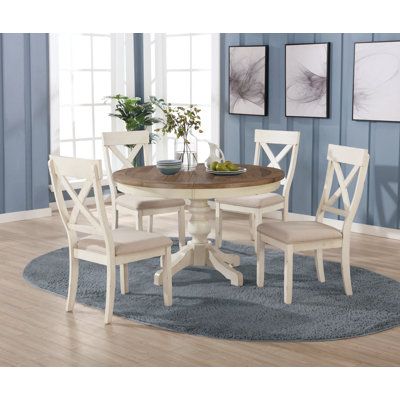 Bring a little of the cozy country farmhouse to your dining room or kitchen with this product. This set is elegant and rustic at once. The round table has a thick, graceful pedestal with an X-shaped base for stability. Its chairs offer country-styled X-shaped backs. Color: White | Ophelia & Co. Cierra 4 - Person Dining Set Wood in White, Size 30.0 H in | Wayfair Commode Shabby Chic, Redecor Game, Kitchen Dinette, White Kitchen Table, Round Back Dining Chairs, Round Table And Chairs, Rectangle Tables, Coastal Vacation, Round Dining Room Table