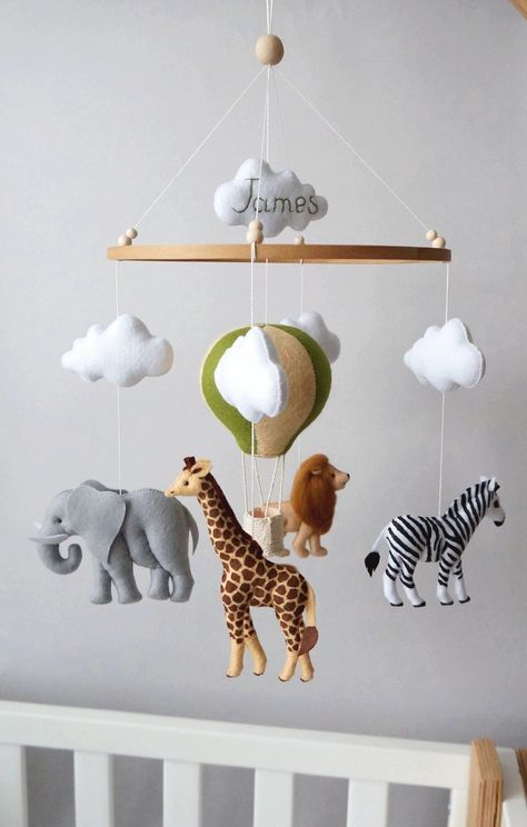 "Safari animals mobile will perfectly match with baby girl, baby boy or gender neutral nursery. Baby mobile is also a perfect gift for new baby or baby shower. ☆ MATERIALS: Half-woolen felt (America) of the highest quality. Hypoallergenic felt (Korea), 100% synthetic. Hypoallergenic hollow fiber filler. Durable nylon cord to hang the toys. ☆ SIZES: Size of toys 4-5.5\" (10-14 cm) Length of the mobile is about 17\" (45 cm) Ring diameter is 9\" (23 cm) ☆ WHAT IS INCLUDED: Baby mobile shown on the Wooden Baby Mobile, Safari Mobile, Hot Air Balloon Mobile, Safari Baby Mobile, Jungle Themed Nursery, Jungle Animals Nursery, Mobile Safari, Balloon Mobile, Toddler Essentials