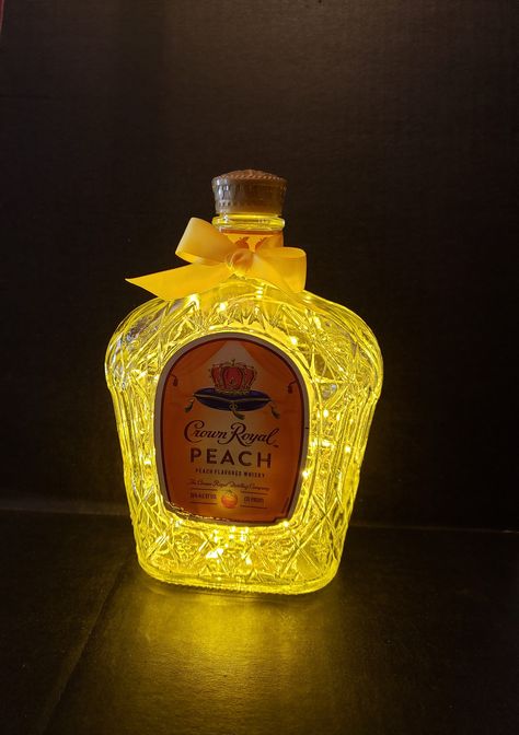 Crown Royal Peach  Illuminated  Liquor bottle.  LED Battery operated lights. Gold Lights Centerpieces With Lights, Crown Royal Peach, 50th Birthday Party Ideas For Men, Crown Royal Bottle, Gold Lights, Liquor Bottle Crafts, Lighted Centerpieces, Bottle Centerpieces, Wedding Bottles