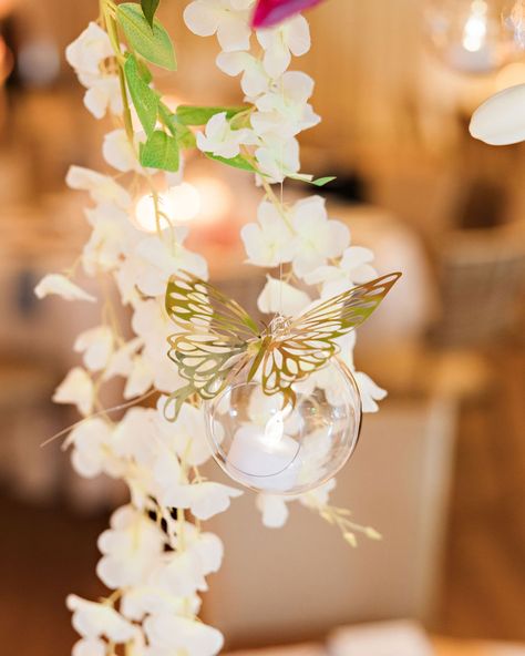 Aubrey and Michael’s wedding theme embraced vibrant spring colors, elegant flares, and butterflies. The bride shared, “I wanted the vibe to represent a spring garden at nighttime. @xohaleighkenney brought the house down with the most amazing large floral displays and installations. Our favorite part was the globes hanging from the centerpieces and floral chandelier. These globes contained a fake votive inside, and then Haleigh attached a gold metallic butterfly onto each of the hanging globes... Floral Chandelier, Floral Display, Spring Garden, Spring Colors, Rehearsal Dinners, Just Married, Night Time, Real Weddings, Candles