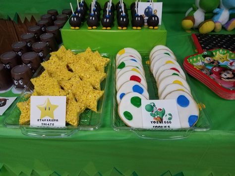 Mario Brothers themed treats:  star rice krispies, Yoshi egg cookies, Bob-omb oreo truffles Super Mario Bros Treat Ideas, Mario Star Rice Crispy Treats, Super Mario Bros Party Treats, Diy Mario Party Food, Super Mario Themed Desserts, Mario Birthday Party Dessert Table, Mario Treat Table, Yoshi Centerpieces, Mario Party Snack Ideas