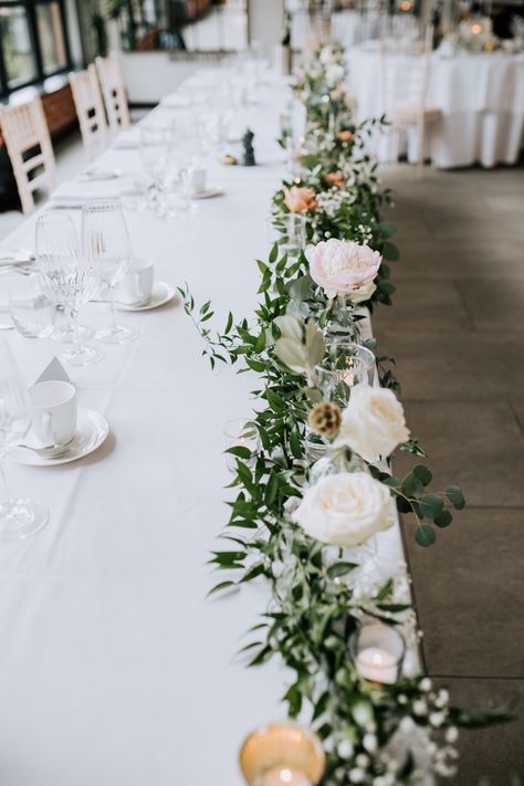 Flowers Laid On Table Wedding, Top Table Floral Display, Bridal Table Decorations Elegant, Wedding Registrar Table Flowers, Simple Top Table Decoration, Wedding Flower Centrepiece, April Wedding Centerpieces, June Wedding Flowers In Season, Top Table Wedding Ideas