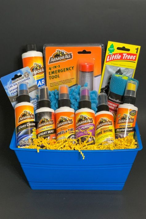 This blue gift basket filled with yellow shred is bright and vibrant contains: All Purpose Car Wash, All Extreme Tire Shine, a 4-in-1 Multi-Function Emergency Tool with a magnetic base that serves as a seatbelt cutter, emergency window hammer, and emergency beacon with a LED flashlight, Glass Cleaner, Wheel & Tire Cleaner, Multi-Purpose Auto Cleaner, New Car Air Freshener, Black Ice Car Air Freshener, New Car Smell Air Freshener, Microfiber Wash Mitt, and a Microfiber Cleaning Towel. Car Gift Basket, Dad Gifts Basket, Tire Cleaner, Ice Car, Fathers Day Gift Basket, Perfect Gift Basket, Tire Shine, Raffle Basket, New Car Smell