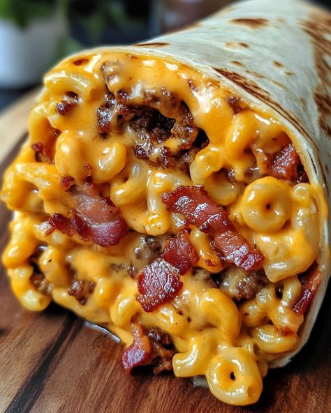 Bacon Macaroni Cheeseburger Wrap 🌯 Ingredients: - 1 lb ground beef - 2 cups cooked macaroni - 6 strips bacon, cooked and crumbled - 1 cup shredded cheddar cheese - 1/4 cup ketchup - 1/4 cup mustard - 4 large flour tortillas Instructions: 1. Cook the ground beef in a skillet over medium heat until browned, breaking it apart with a spoon. Drain excess fat. 2. Mix in the cooked macaroni, crumbled bacon, shredded cheddar cheese, ketchup, and mustard. Stir until well combined and the ch... Bacon Macaroni Cheeseburger Wrap, Recipe With Velveeta, Bacon Mac N Cheese Burger Wrap, Loaded Bacon Cheeseburger Tacos, Cheesy Bacon Burger Wraps, Bacon Cheeseburger Wraps, Bacon Mac And Cheese Burger Wrap, Viral Food Trends, Morning Food Ideas