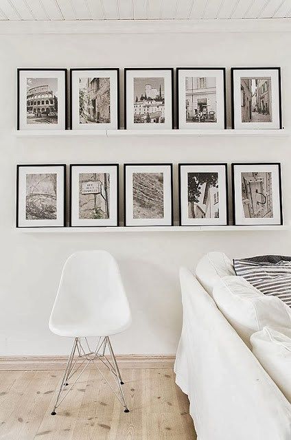 A touch of black in the form of framed black and white photos on the floating shelves adds just the right amount of contrast. Scandinavian Country Style, Travel Photos Display, Koti Diy, Diy Home Decor For Apartments, Creative Wall Decor, Photo Wall Gallery, Dekor Diy, White Living, White Living Room