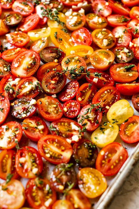 A Slow Roasted Cherry Tomatoes recipe, perfect for your summer garden harvest! Sweet & juicy cherry tomatoes slowly roast in the oven with olive oil, garlic, & fresh herbs, resulting in intensely sweet-tart tomatoes with the most wonderful hearty texture. Roasted tomatoes are perfect for tossing in pasta, salads, sandwiches, on pizzas, adding to a cheese board, or simply snacking by the handful – a summer staple! #roastedtomatoes #ovenroastedtomatoes #sundriedtomatorecipes #tomatorecipes Slow Roasted Vegetables, Sundried Cherry Tomatoes Oven, Sundried Cherry Tomato Recipes, Slow Roasted Cherry Tomatoes Oven, Cherry Tomato Roasted, Slow Roasted Tomatoes Oven, Sun Dried Cherry Tomatoes In Oven, Slow Roasted Cherry Tomatoes, Sundried Tomatoes In The Oven