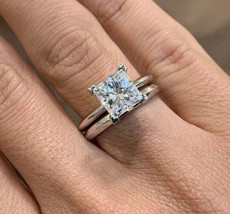 Celebrate your love and commitment with this exquisite Princess Cut Moissanite Wedding Ring Bridal Set. Expertly handcrafted, this set includes an engagement ring and a matching wedding band, designed to complement each other perfectly. The engagement ring features a mesmerizing princess cut Moissanite stone, known for its exceptional brilliance and fire. It is delicately set in a lustrous white gold band, accentuated by smaller, shimmering diamonds along the band. The matching wedding band is c Princess Cut Engagement Ring And Band, Platinum Princess Cut Engagement Ring, Princess Cut Engagement Ring With Band, Princess Cut Engagement Rings Gold, Princess Cut Ring Set, Solitaire Wedding Set, Set Wedding Rings, Solitaire Wedding Ring Set, Princess Cut Solitaire Ring