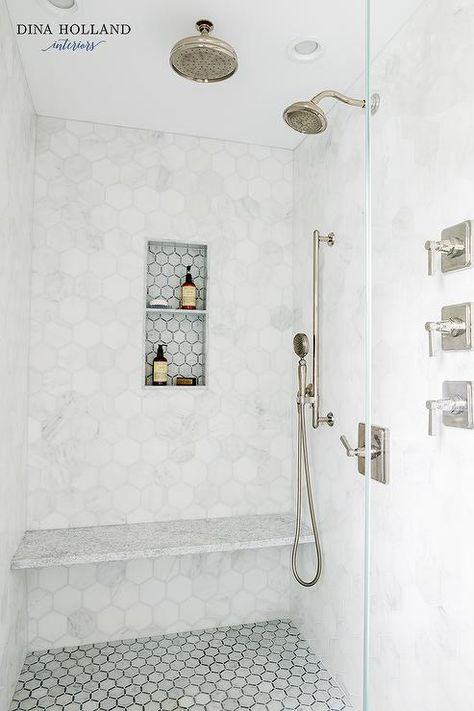 A seamless glass walk-in shower boasts white marble hex floor tiles fixed beneath a white stone floating bench mounted to white marble hex wall tiles fixed framing a gray hex tiled niche. Hexagon Shower Wall Tile, Shower Head Placement, Shower Remodel Diy, Small Shower Remodel, Shower Renovation, Custom Tile Shower, Shower Wall Tile, Small Showers, Transitional Bathroom