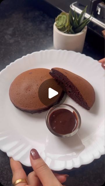 Foodie | Recipe | Delicious on Instagram: "Chocolate Dora Cakes 🍫🥮

Recipe by @myflavourfuljourney 

Ingredients:

	•	1 cup all-purpose flour
	•	1/2 cup icing sugar
	•	1/4 cup cocoa powder
	•	1/4 cup milk powder
	•	1 tsp coffee powder
	•	1/2 tsp baking soda
	•	Pinch of salt
	•	1 cup milk

Instructions:

	1.	Mix all ingredients to form a smooth batter.
	2.	Pour batter into a heated nonstick pan. Cook on low heat for 1 minute with the lid on, then flip and cook for 30 seconds.
	3.	Spread chocolate spread or Nutella on one pancake, then sandwich with another.

Your Chocolate Dora Cakes are ready!

#doracakes #foodphotography #doraemon #doremon #doracake #foodstagram #doraemonlover #nutella #homemade #love #foodiesofinstagram #foodie #egglessbaking #food #japanesecuisine #doraemonnodaisuki # Dora Cake Recipe, Dora Cake, Chocolate Pancakes, Eggless Baking, Chocolate Spread, Icing Sugar, Coffee Powder, Milk Powder, Pastry Cake