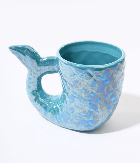 Dive into your morning routine! Made from a beautiful ceramic in a captivating ocean blue shade, this mug emulates the graceful beauty of a mermaid's tail. Whether you're sipping on your favorite coffee or enjoying a soothing cup of tea, let this whimsical accessory transport you to an underwater paradise.Available while supplies last. Blue Mermaid Tail, Mermaid Mug, Mermaid Cup, Mermaid Mugs, Whimsical Accessories, Clay Cup, Blue Mermaid, Mermaid Tail, Cup Of Tea