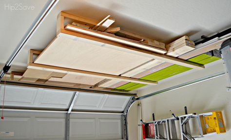 Scrapwood Organizer above garage door Hip2Save Garage Door Storage, Diy Lumber Storage, Garage Organization Shelves, Garage Wall Shelving, Lumber Storage Rack, Garage Ceiling Storage, Ladder Storage, Overhead Garage Storage, Lumber Storage