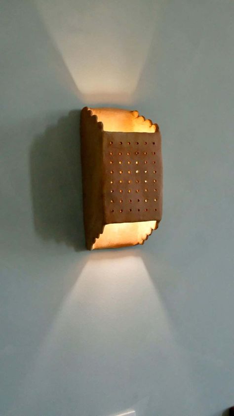 For Sale on 1stDibs - - Handbuilt terracotta ceramic wall light - made of clay collected from the potter's surroundings. - made in the Moroccan Rif mountains by the potter Houda. Wall Lamp Wood Design, Terracotta Wall Lights, Ceramic Wall Lights Sconces, Ceramic Illuminaries, Ceramic Wall Lamp, Clay Lighting, Ceramic Sconces, Terracotta Ceramics, Mediterranean Wall Sconces