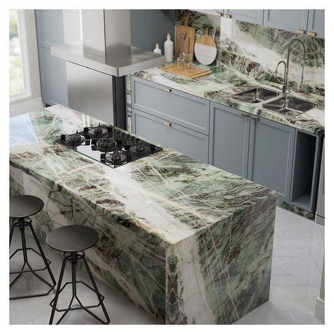 Bring wilderness to your kitchen with Moldavite Crystal | Quartzite With white and brown veins, the Moldavite Crystal quartzite is a sight to behold. It’s green base brings a wilderness theme to spaces, making it a unique and chic choice for your kitchens! #taxilastone #inspiredsurfaces #naturalstones #marbled #marbledesign #usenaturalstone #naturalstone #renovatie #concretefinish #commerical #richmondtx #stagingsells #mastersofdesign #stonesupplier #lands #insporation #instalation#finds Green Quartzite Countertops, Quartzite Kitchen Island, Quartzite Kitchen Countertops, Kitchen Design Centre, Moldavite Crystal, Stone Granite, Kitchen Mood Board, Quartz Kitchen Countertops, Concrete Finish