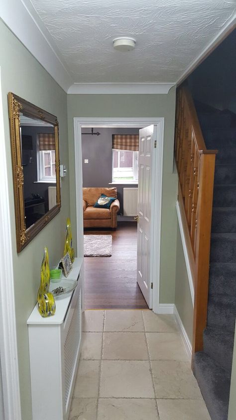 Overtly olive Hallway with brown stairs Sage Green And Grey Hallway Ideas, Sage And Grey Hallway, Safe Green Hallway, Hallway Wall Paint Ideas, Olive Hallway Ideas, Sage Green Hallway And Stairs, Olive Green Hallway Ideas, Overtly Olive Hallway, Green Hallway Ideas Entrance Halls