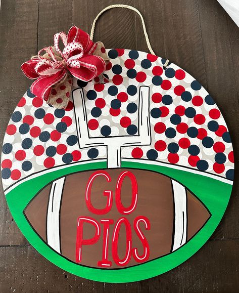 Hand painted football door sign. This is an 18" wooden round sign. These signs sealed, but recommended for use on a covered porch. Your sign is personalized to the colors to cheer on your favorite team. Please make sure to leave all specifications in notes section. Football Front Door Sign, Hand Painted Porch Signs, Football And Fall Door Hanger, High School Football Door Hanger, Uga Door Hanger, Round Wooden Door Hangers Diy Fall, Football Door Decorations, Football Season Door Hangers, Football Door Hanger Wooden