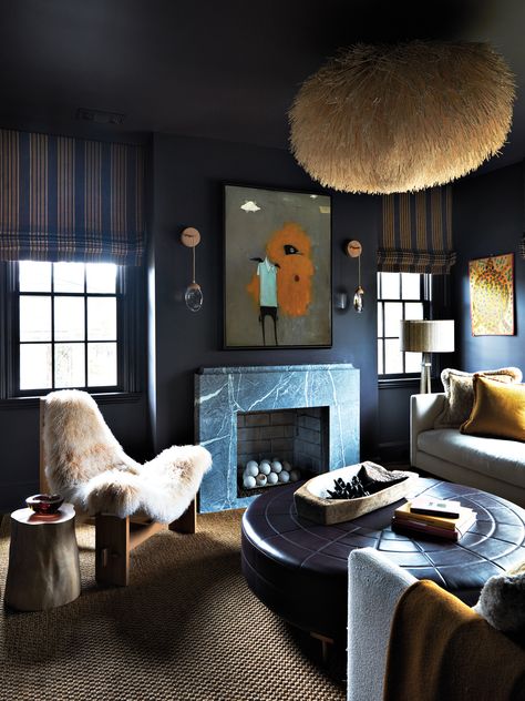 Sherwin-Williams’ Darkroom coats the den, where a Sea Urchin pendant and sheepskin Sling chair, both by Coup Studio, join the Lee Industries sectional and Natasha Baradaran leather cocktail table. Ochre sconces flank a Michele Mikesell artwork. Moody Living Room Ideas, Den Fireplace, Moody Living Room, Moody Interiors, Waffle House, Interior Design Guide, Atlanta Homes, Luxe Interiors, Southern Home