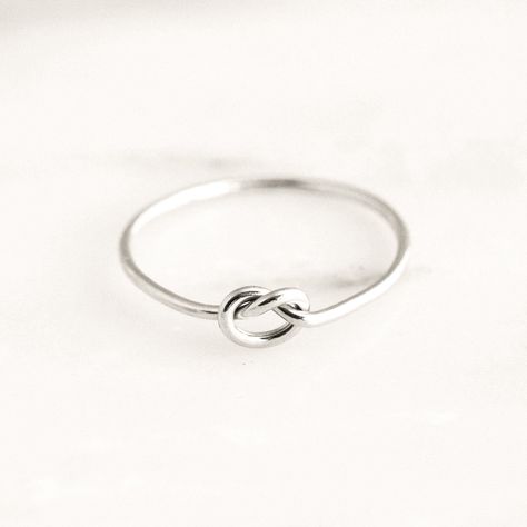 Our Love Knot Ring will be the daintiest addition to your collection. It can be worn as a symbol of eternity and love - making it the perfect gift for your loved one. Pair it with our simple stacking ring or any of our other rings for a dainty look! DETAILS 14k gold filled -or- sterling silver ring 1mm band Available in sizes 3-9 Safe for sensitive skin & shower safe Matching earrings: Love Knot Stud Earrings Bundle & Save up to 25% if you're buying multiple rings Dainty Initial Necklace, Love Knot Ring, Jewelry Knots, Basic Jewelry, Silver Stacking Rings, Knot Ring, Gold Ring Stack, Gold Filled Ring, Love Knot