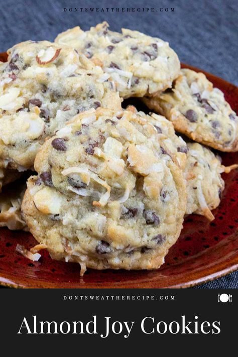 Almond Joy cookies are a blend of sweet coconut, semi-sweet chocolate chips, and sliced almonds. A delicious twist on your favorite candy bar! Almond Joy Chocolate Chip Cookies, Desserts With Sliced Almonds, Almond Joy Cookies Best, Almond Joy Pie Recipe, Coconut Cake Cookies, Recipes With Sliced Almonds, Desserts With Almonds, Almond Joy Cookies Recipe, Candy Bar Cookies Recipes