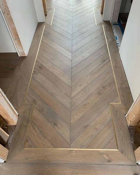 S/H Builders on Instagram: "Deep Basement; Entry Chevron Floors with metal inlays installed, crowns, beams, trim work and countertops continue Happy Friday! @nlielasus @northworks_architects" Chevron Wood Floor Entryway, Herringbone Inlay Floor, Herringbone Wood Floor Foyer Entryway, Hardwood Floor Inlay, Herringbone Lvp Flooring, Herringbone Wood Floor Entryway, Herringbone Foyer, Chevron Entryway, Brass Inlay Floor