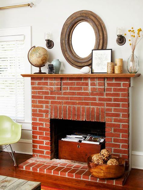 Savvy Storage  Don't let a nonworking fireplace become an unused area. A firebox is a small space that can be used for storage in a stylish way... Fireplace Filler, Mirror Above Fireplace, Fireplace Styles, Fireplace Modern Design, Unused Fireplace, Red Brick Fireplaces, Diy Mantel, Magazine Storage, Traditional Fireplace