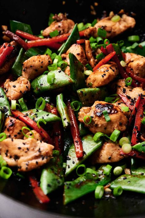 A close-up of a stir-fry dish featuring kung pao chicken - diced chicken, snap peas, and bell pepper strips, reminiscent of kung pao chicken, garnished with chopped green onions and black sesame seeds. Chicken Snap, Kung Pao Chicken Recipe Easy, Unique Chicken Recipes, Kung Pao Chicken Recipe, Miso Chicken, Chicken And Chips, Chinese Recipe, Authentic Chinese Recipes, Stir Fry Dishes