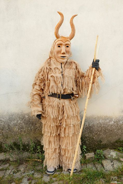 In this photo taken on Saturday, Jan. 7, 2017, a 'Careto de Lazarim' wearing an ancient mask poses for a photo, during a winter masquerade gathering in Salsas, Portugal. (AP Photo/Daniel Ochoa de Olza) Winter Masquerade, Crazy Costumes, Pagan Rituals, Mardi Gras Costumes, Costume Mask, African Masks, Arte Popular, Cool Costumes, Puppets