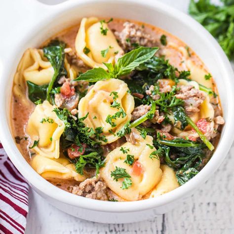 This incredible creamy tortellini soup with spinach is a delicious mix of tomatoes, sausage, and pasta. It's a versatile, easy dinner. Sausage Tortellini Soup Stovetop, Tortellini Soup Stovetop, Easy Sausage Tortellini Soup, Tortellini Soup With Spinach, Tortellini Soup With Italian Sausage, Soup With Italian Sausage, Sausage And Pasta, Dinner Menu Planning, Soup With Spinach