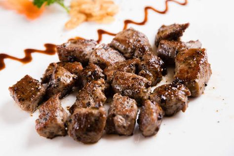 Steak Bites and Garlic Mushrooms - bm4221/istockphoto Steak Tips Marinade, Steak Tip Marinade, Bacon Dishes, Steak Tips, Cooking Photos, Light Salad, Marinated Steak, Grilled Peaches, Steak Bites