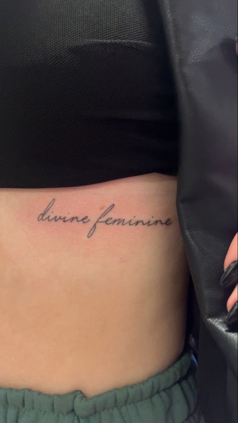 tattoo idea Women Tattoos Underboob, Devine Feminine Tattoos For Women, Devine Femine Tattoo, Devine Feminine Tattoo Ideas, Divine Feminine Tattoo Cursive, Feminine Word Tattoos, Define Feminine Tattoo, Underboob Word Tattoo, Tattoos For Women Underboob