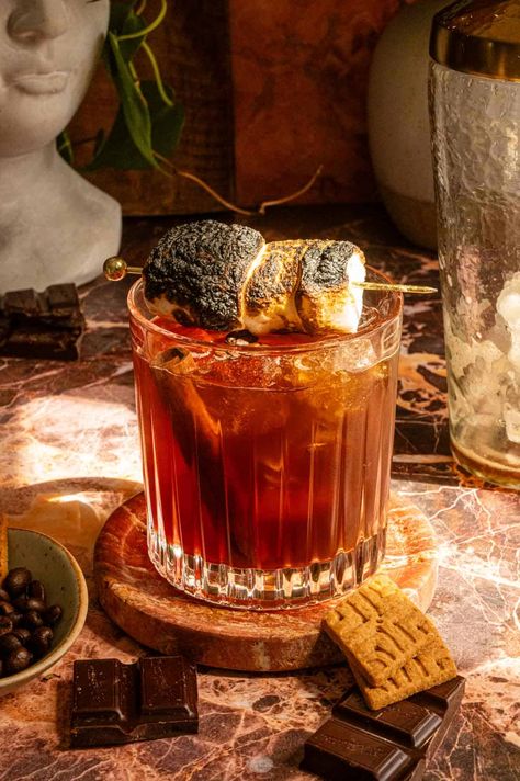 This smore's carajillo is a riff on the Mexican cocktail that combines Licor 43 and espresso. This version ups the ante and adds mezcal, chocolate bitters, and cinnamon bitters for a smokier and spicier twist on the classic. Smores Cocktail, Mexican Cocktail, Chocolate Bitters, Mexican Cocktails, Cocktail Drinks Alcoholic, Cocktail Drinks, Espresso, Ups, Cinnamon