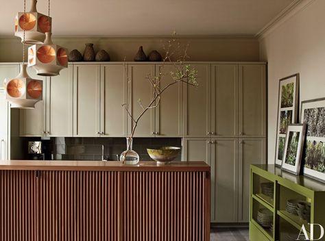 Barneys's Mark Lee and KCD's Ed Filipowski called on architects Janson Goldstein to transform their Manhattan penthouse. The kitchen cabinets are painted in Benjamin Moore’s Gettysburg Gray, while Sherwin-Williams’s Ethereal Mood coats the walls. The backsplash is by Artistic Tile, the nickel hardware is by Nanz, and the light fixture is vintage Moroccan. Manhattan Kitchen, Kitchen Cabinet Storage Solutions, Above Kitchen Cabinets, Above Cabinets, Smart Kitchen, New York Apartment, Grey Kitchens, Kitchen Cabinet Storage, Kitchen Color